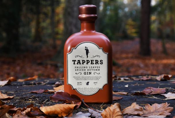 a bottle of falling leaves gin in a woodland setting