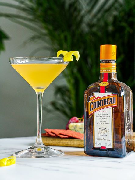 a bottle of orange liqueur with a cocktail
