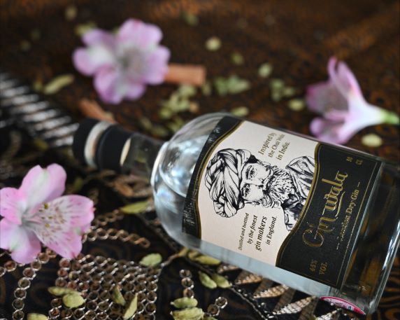 a bottle of gin wala on a sari with flowers and spices
