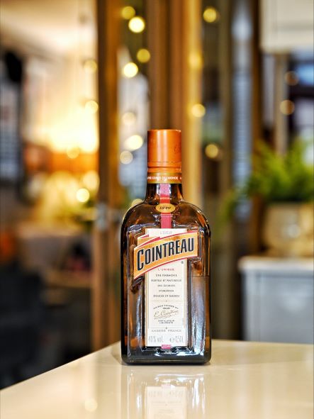 a bottle of orange liqueur with ambient light