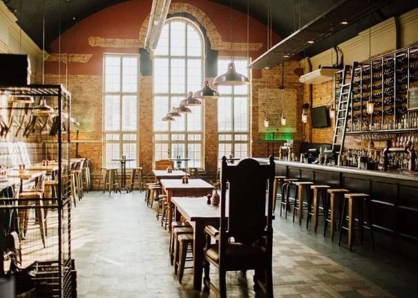 bar and drinking area showing stocked bar, tables and chairs