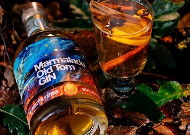 A BOTTLE OF MARMALADE OLD TOM AND A COCKTAIL IN A WOODLAND SETTING