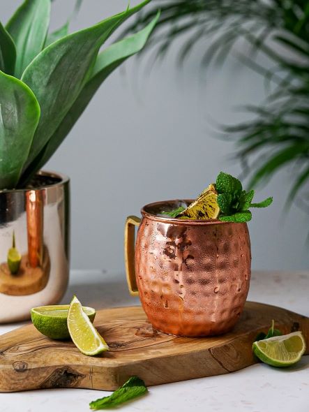The Moscow Mule in a copper mug garnished with lime